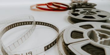 four reel films lying on white table