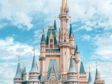 white and blue castle under blue sky and white clouds during daytime